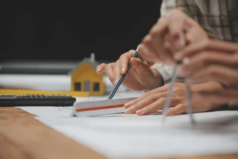 Team of multiethnic architects working on construction plans in meeting roo.. Stock Photos