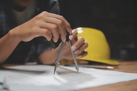 Team of multiethnic architects working on construction plans in meeting roo.. Stock Photos
