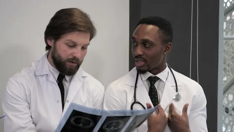 Team of multinational doctors in a modern clinic. Brainstorming medical staff. 스톡 동영상 144834069