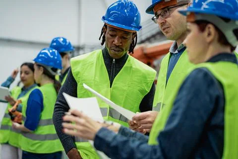 Team of multiracial engineers working in robotic factory - Tech industry concept 스톡 사진