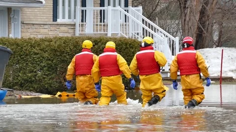 Team Of Nautical Firefighters Walking Through Flood Water Stock Footage 76758499