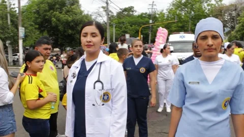A team of nurses marching in a military parade Stock Footage 313684616