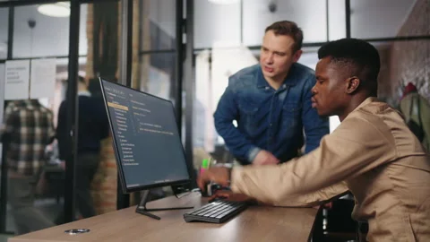 Team Of Office Workers Discussing Project, Multiethnic Men Are Looking At Stock Footage 236630031