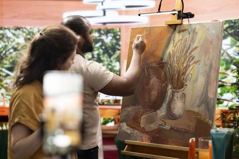 Team of painters recording an artistic tutorial for the internet Stock Photos