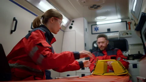 Team paramedics getting ready for patient resuscitation in emergency vehicle Stock Footage 166904171