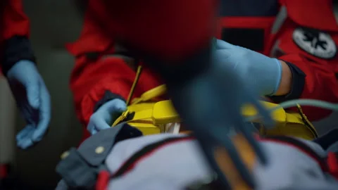 Team of paramedics providing first aid help for injured patient in ambulance car Stockbeeldmateriaal 166867040