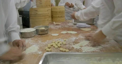 Team of Passionate chiefs preparing Shoronpo dumblings at Taiwan Restaurant Stock Footage