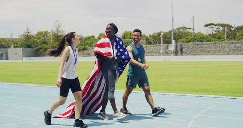 Team of patriotic olympic athletes celebrating victory, walking and cheering on Stock Footage