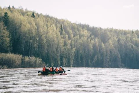 Team of people float down the River on inflatable catamaran Stock Photos