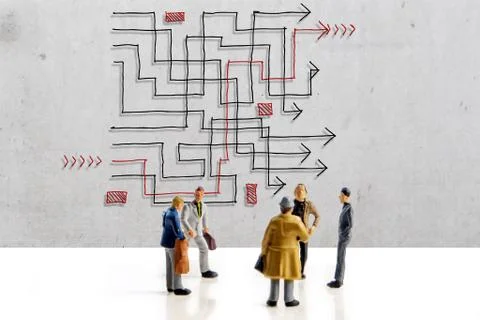 Team of people solving a difficult maze problem, finding best possible soluti Stock Photos
