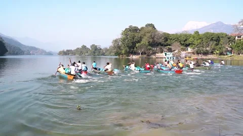 Team of peoples competing to win the paddle boat race at Fewa Lake. Stock Footage 130592180