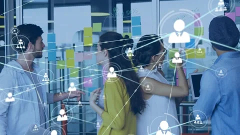 Team pointing at glass wall Postits, sparking animated node web floating across Video stock 329786386