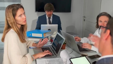 Team preparing client presentation, colleagues engaged in preparing professional Stock Footage 319565545