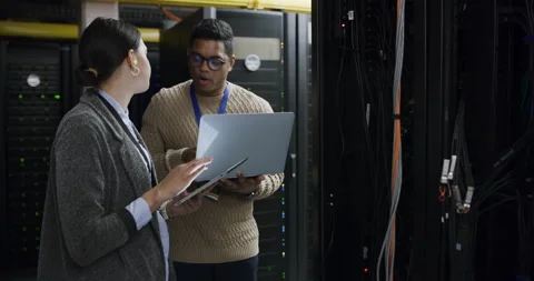 Team, problem solving and data center, woman and man with tablet, laptop and Stock Footage 243024969