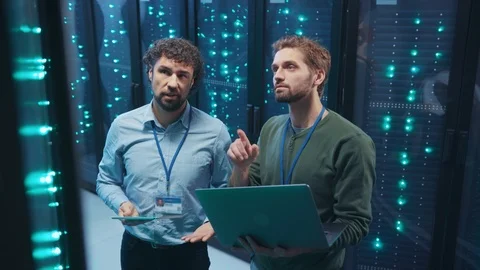 Team of professional data center engineers setting server hardware working on Stock Footage 119975201