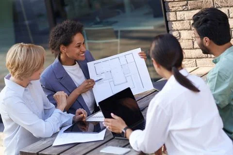 Team of professional design engineers working with project documents in office Stock Photos