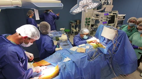 Team of professional doctors operating in clinical room. Main surgeon performing Stock Footage 164960943