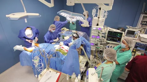 Team of professional doctors performing surgical operation in hospital. Elderly Stock Footage 164961072