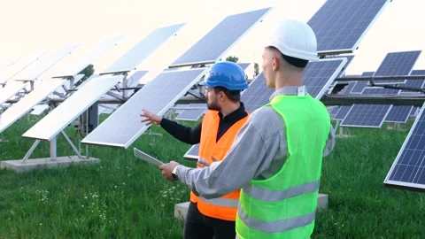 A team of professional engineers learning the design of the solar plant paper Stock Footage 140002252