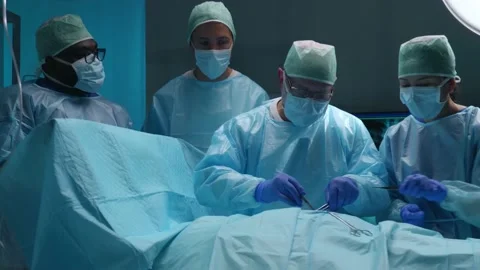 Team of professional medical surgeons performs the surgical operation in a Stockbeeldmateriaal 167263349