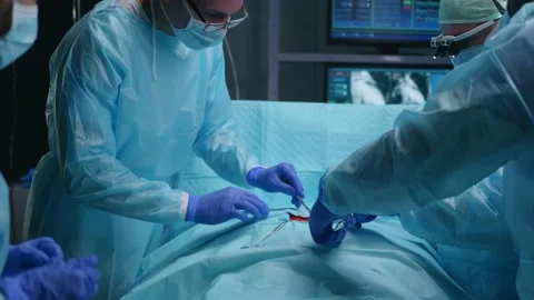 Team of professional medical surgeons performs the surgical operation in a Stock Footage 167716257