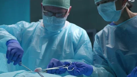 Team of professional medical surgeons performs the surgical operation in a Stock Footage 167970922