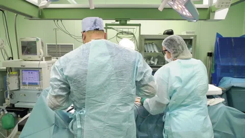 Team of professional multi-race doctors operating surgery in hospital room Stock-Footage 162561245