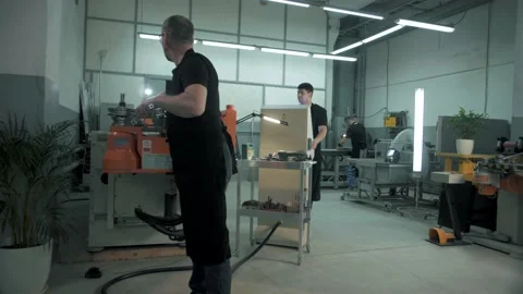 Team of professional workers maintain a huge numerically controlled machine Stock Footage 179700085