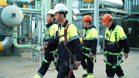 Team of professional workers in protective clothes and hard hat walking on Stock-Footage 100146521