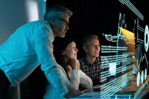 Team of Professionals Analyzing Data on Large Digital Screen Stock Photos