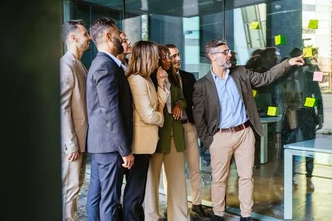 Team of Professionals Brainstorming with Sticky Notes in Modern Office Stock Photos