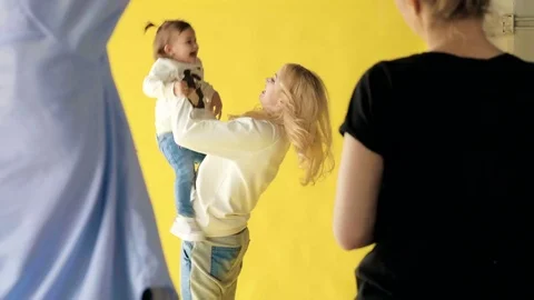 Team of professionals working on a photo shoot of the smiling happy mother and Stock Footage 78245845