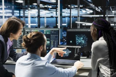 Team of programmers brainstorming in data center, optimizing equipment for AI Foto stock