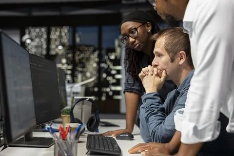 Team of programmers cooperating in AI focused startup Stock Photos