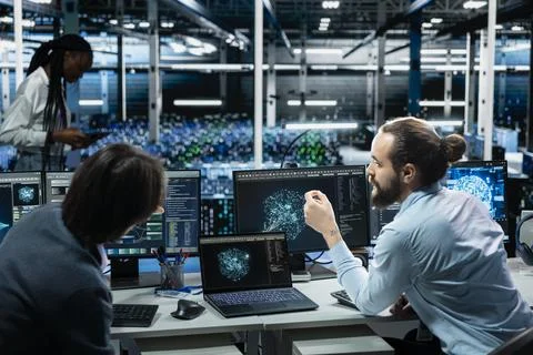 Team of programmers in data center installing server systems helped by AI Foto stock