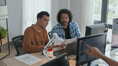 Team of Programmers Discussing Documents in Office Stock Footage 203732321