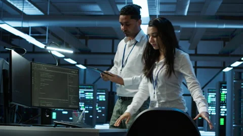 Team of programmers in high tech data center troubleshooting issues Stock Footage 280724473