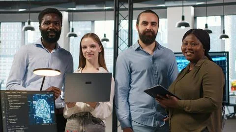 Team of programmers in office automating repetitive tasks using AI scripts 库存照片