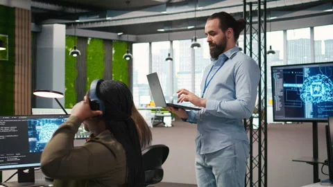 Team of programmers in office developing software applications using AI Stock Footage 313167480