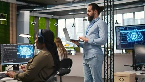 Team of programmers in office developing software applications using AI Stockfoto's