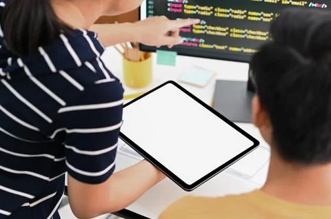 Team of programmers with tablet and computer is programming to present cust.. Stockfoto's