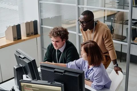 Team of programmers working on computers Fotos Stock