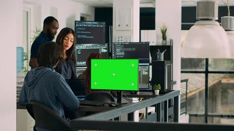 Team of programmers working on source code with greenscreen monitor Stockfoto's