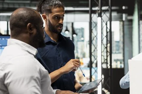 Team of property developers evaluating construction design and 3D models Stock Photos