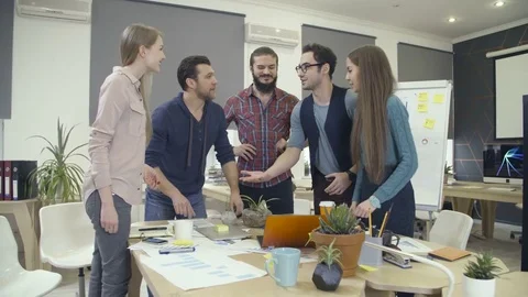 Team putting hands together and raising arms up Stock Footage 72563989