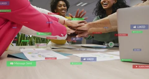 Team reaching in stacking palms to launch marketing push, laptop social overlays Stock Footage 330227467