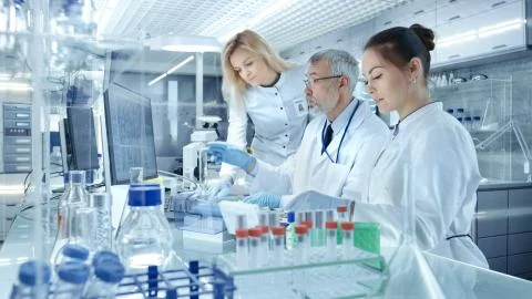 Team of Research Scientists Working With Personal Computer, Analysing Test Tr Stock Photos