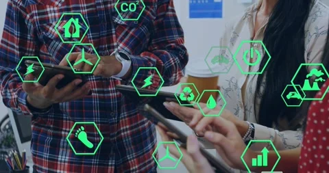 Team reviewing energy data, tapping and swiping devices, causing green hexes Stock Footage 329835672