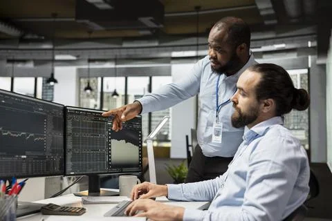 Team of risk analysts using trading platform to identify market volatility signs Stock Photos