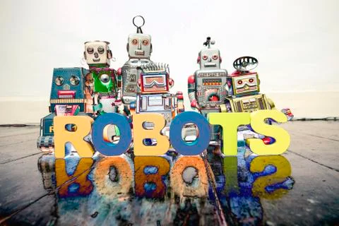A team of robit toy coders on an old wooden floor Foto stock